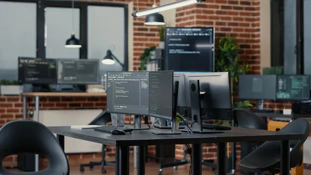Modern IT workspace with multiple monitors displaying code in a collaborative office environment